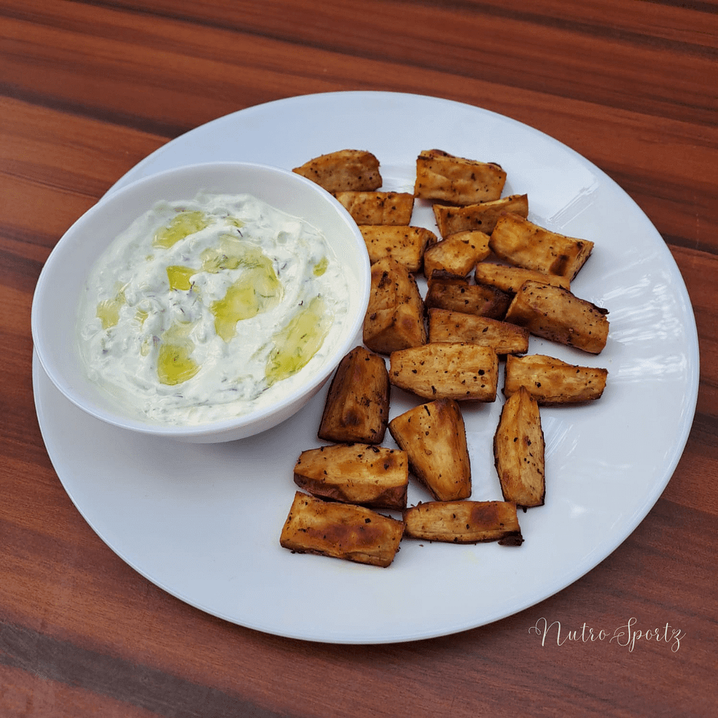 An image of sweet potato wedges with tzatziki.