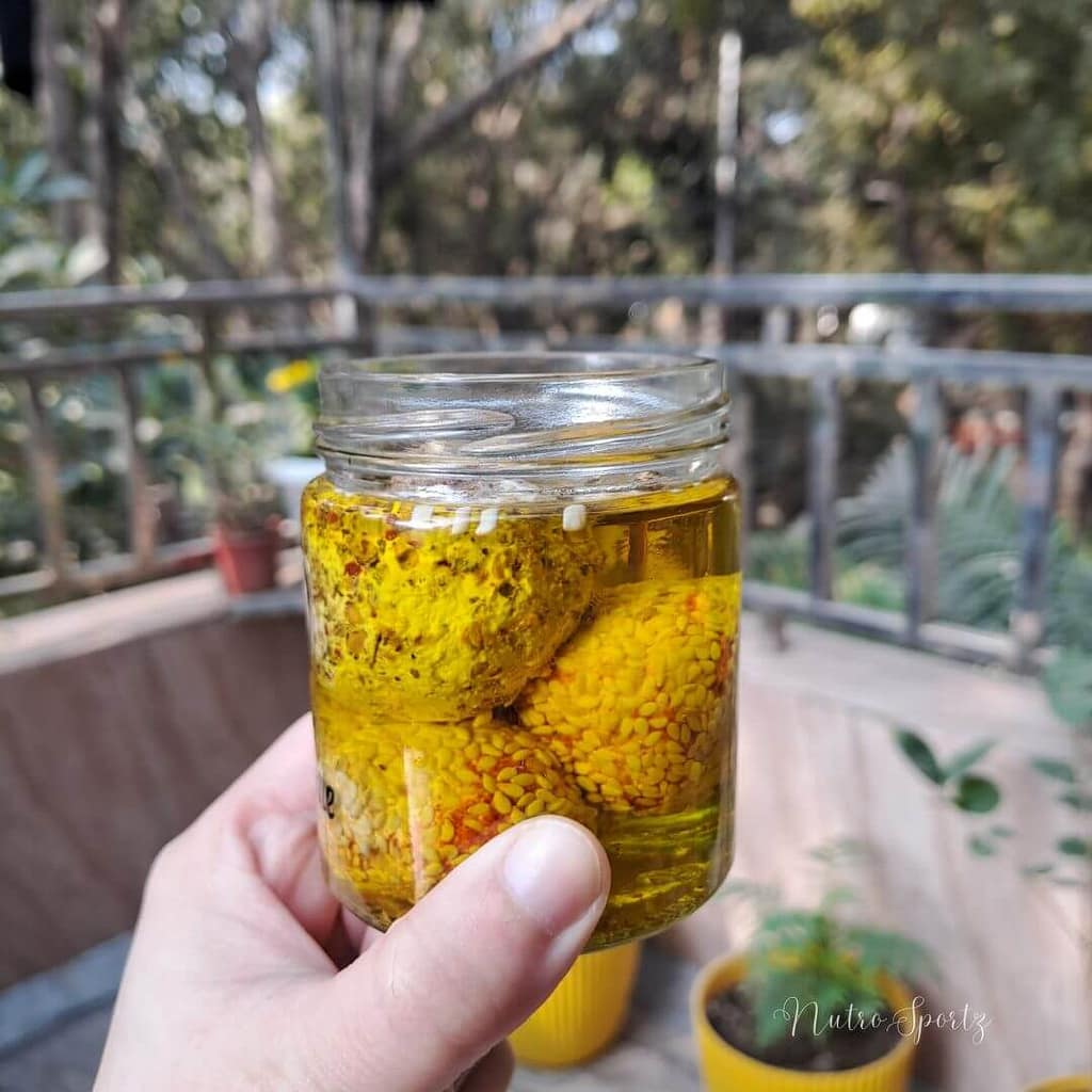 An image of labneh balls in a jar.
