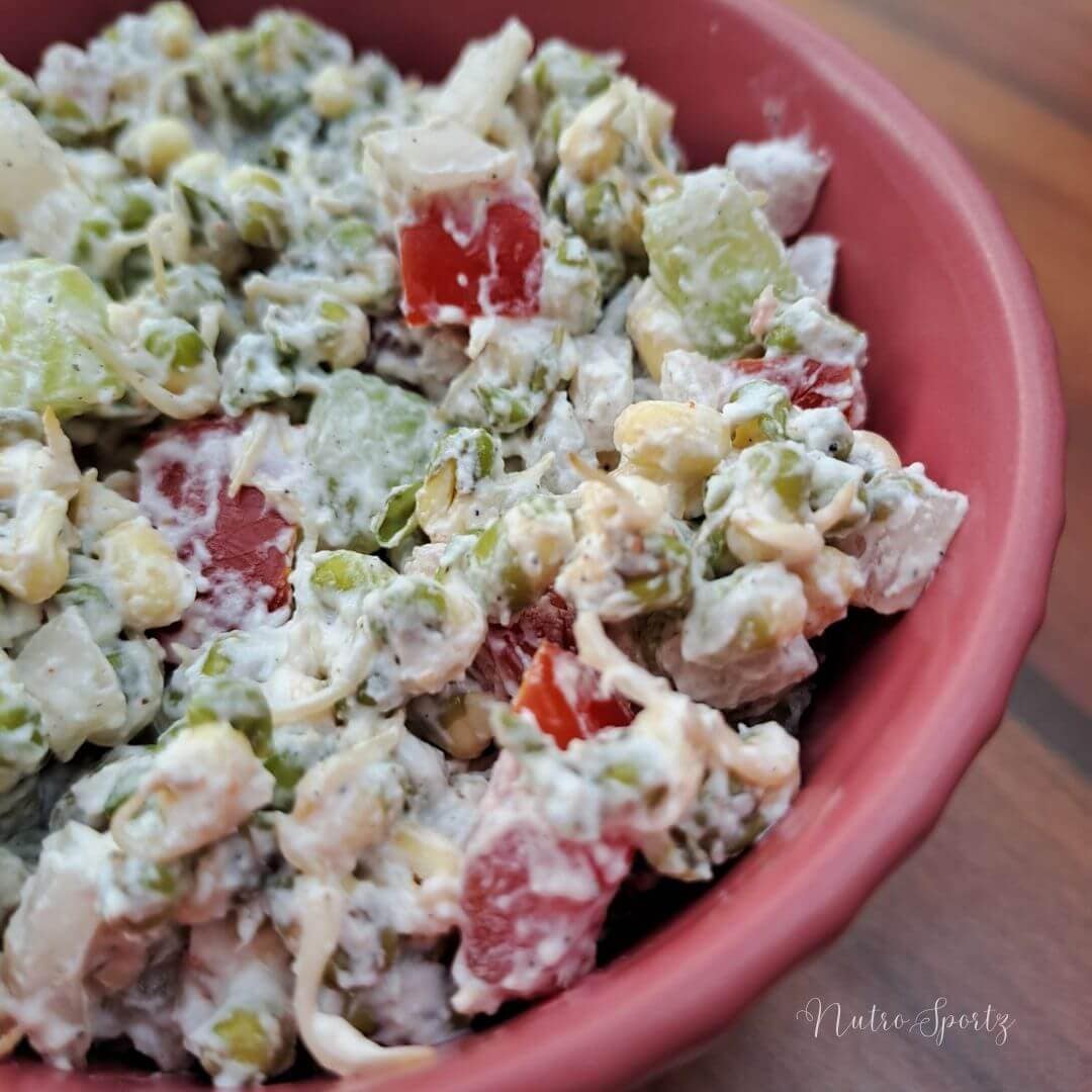 An image of moong dal sprouts salad- creamy version in a bowl.
