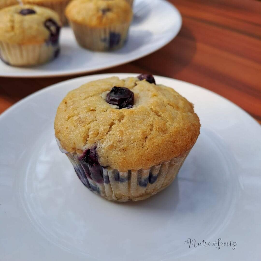 An image of eggless blueberry oats muffins on a plate.