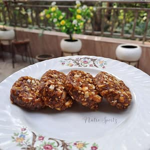 An image of dry fruit burfi on a plate.