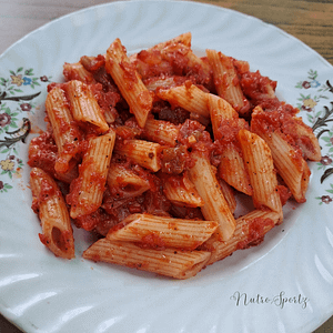 An image of red sauce pasta on a plate.