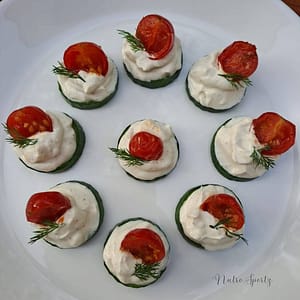 An image of cucumber canapés on a plate.